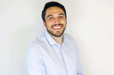 Jason long, man with dark hair and beard wearing white shirt and smiling